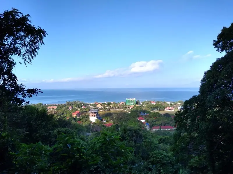 View through the forest of Kep National Park over Kep town and the sea