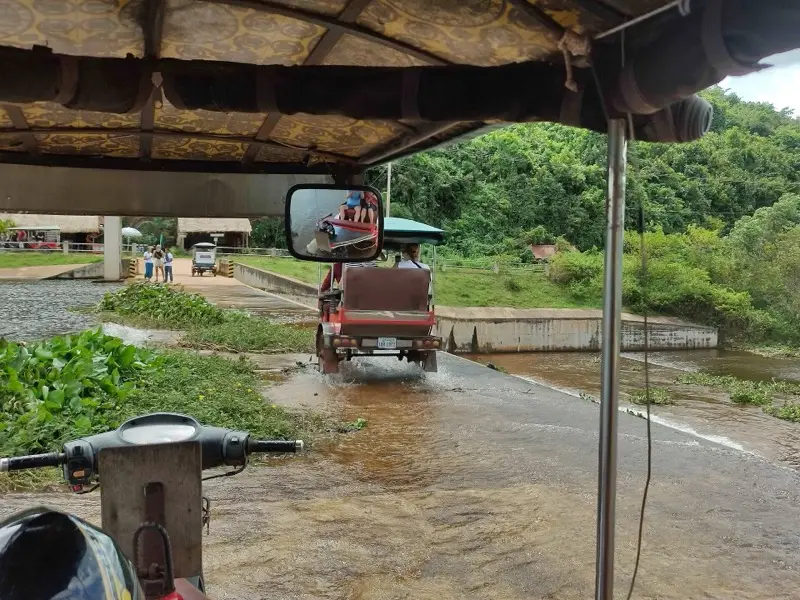 Ein Tuk-Tuk überquert den Damm am Secret Lake bei Kampot